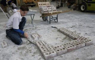 Student laying brick on masonry job